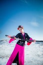 Geisha with katana in black and pink kimomo on winter landscape and blue sky background. Royalty Free Stock Photo