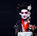 Geisha in kimono on black