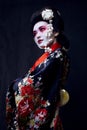 Geisha in kimono on black