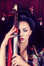 Geisha in kimono with samurai sword Royalty Free Stock Photo