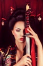 Geisha in kimono with samurai sword Royalty Free Stock Photo