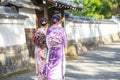 Geishas girl wearing Japanese kimono among red wooden Tori Gate at Fushimi Inari Shrine in Kyoto, Kimono is a Japanese traditional Royalty Free Stock Photo