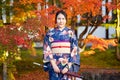 Geishas girl wearing Japanese kimono among red wooden Tori Gate at Fushimi Inari Shrine in Kyoto, Kimono is a Japanese traditional Royalty Free Stock Photo