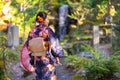 Geishas girl wearing Japanese kimono among red wooden Tori Gate at Fushimi Inari Shrine in Kyoto, Kimono is a Japanese traditional Royalty Free Stock Photo