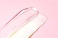 Gel and cream double texture swatch smear on pink background, transparent snail mucin serum skin care product stroke