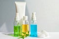 Gel green and blue, yellow oil for face care in glass bottles. Jar of cream and a white tube. leaves and flowers Royalty Free Stock Photo