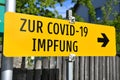 Yellow sign `To Corona vaccination` in Austria Royalty Free Stock Photo