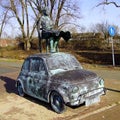 Bronze cast Fiat 500 with woman on top.