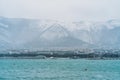 Gelendzhik city in winter in snowy weather, mountains covered with snow, waves and wind on sea bay water surface, no