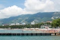 Gelendzhik, Russia people relax on the beach with mountains in the background