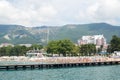 Gelendzhik, Russia people relax on the beach with mountains in the background