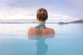 Geothermal spa in Iceland with young woman enjoying bathing in hot thermal pool with hotspring water for wellness and skin Royalty Free Stock Photo