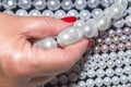 Gemologist assesses quality of pearls Royalty Free Stock Photo