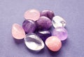 Gems of various colors. Amethyst, rose quartz and rock crystal on gray background