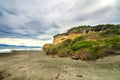 Dramatic seascape of windy wild black sand beach in Southland, Catlins, Gemstone beach, Orepuki, New Zealand, South Pacific ocean Royalty Free Stock Photo