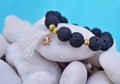 Gemstone bracelet with black Lava beads and pendant starfish - volcano stones Royalty Free Stock Photo
