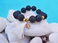 Gemstone bracelet with black Lava beads and pendant starfish - volcano stones Royalty Free Stock Photo