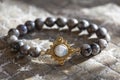 gemstone bracelet placed on natural grey background