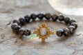 Gemstone bracelet placed on natural grey background