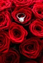 Beautiful white gold pearl ring and bouquet of red roses, luxury jewelry love gift on Valentines Day and romantic holidays Royalty Free Stock Photo