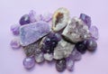 Gemstone minerals on a white background. Round tumbling minerals of amethyst and amethyst crystal