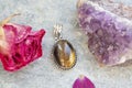 gemstone pendant in silver metal decorative oval on natural backhround