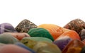 Gemstones background image. Macro shot of colorful gemstones on white.
