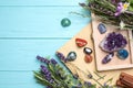 Gemstones and healing herbs on blue wooden table, flat lay. Space for text