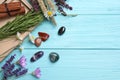 Gemstones and healing herbs on blue wooden table, flat lay. Space for text