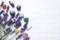 Gemstones and healing herbs on white table, flat lay. Space for text