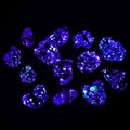 Gemstones with oil inside shining blue under a UV light