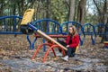 Gen z, generation z, Zoomers device addiction, digital detox. Teenager girl alone rides on a swing in an autumn park