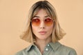 Gen z girl with short blond hair wearing sunglasses looking aside. Portrait Royalty Free Stock Photo