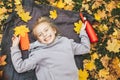 Gen z teenage girl using smartphote outdoors in autumn time.