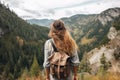 gen z woman travels through the mountains of wild nature. AI Generated