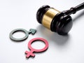Gender discrimination concept. Male and female symbols near a gavel.