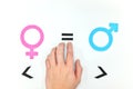 Gender equality concept. Hand holding equal sign between male and female symbol.