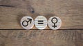 Gender equality conceptual image. Male and female symbol on wooden circles on beautiful wooden background. Copy space Royalty Free Stock Photo