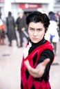 Gender fluid cosplayer close up with colourful contact lenses and face piercings