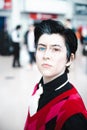 Gender fluid cosplayer close up with colourful contact lenses and face piercings