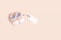 Gender neutral baby shoes with mockup tag Royalty Free Stock Photo