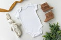 Gender Neutral Blank White Baby Bodysuit Flat lay Mockup