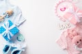 Top view photo of pink and blue infant clothes gift boxes knitted bunny rattle toy shoes pacifiers teether chain inscription love Royalty Free Stock Photo