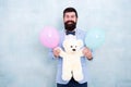 Gender reveal party. Traditional pattern of giving gifts. Valentines day. Romantic man with teddy bear and air balloons