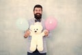 Gender reveal party. Traditional pattern of giving gifts. Valentines day. Romantic man with teddy bear and air balloons