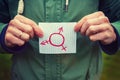Gender symbols. caucasian white adult man holding in hands paper with inscription on it transgender symbols. Human rights freedom Royalty Free Stock Photo