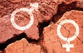 Gender symbols on earth background with a big crack