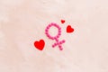 Gender Venus symbol made of contraceptive pills, near heart sign - woman health concept - on beige background top-down