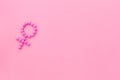 Gender Venus symbol made of contraceptive pills - woman health concept - on pink background top-down copy space