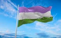 Genderqueer Pride flag waving in the wind at cloudy sky. Freedom and love concept. Pride month. activism, community and freedom